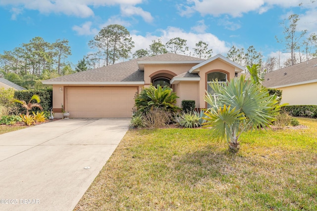 view of front of property with a garage and a front lawn