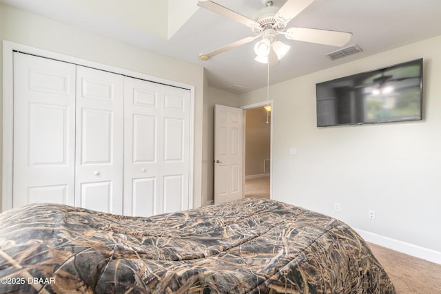 carpeted bedroom featuring a closet and ceiling fan