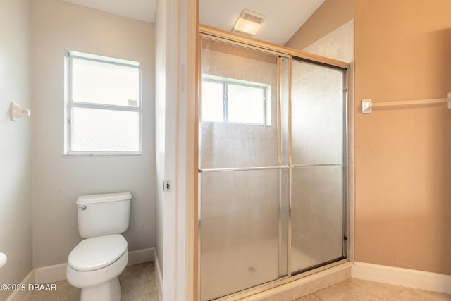 bathroom with toilet, tile patterned flooring, and a shower with door