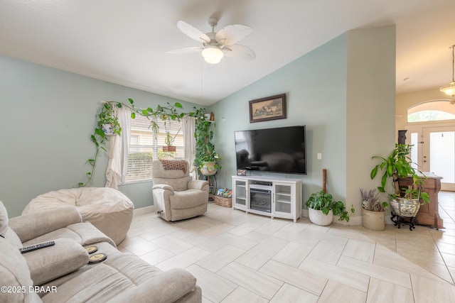 living room featuring lofted ceiling, light tile patterned floors, and ceiling fan