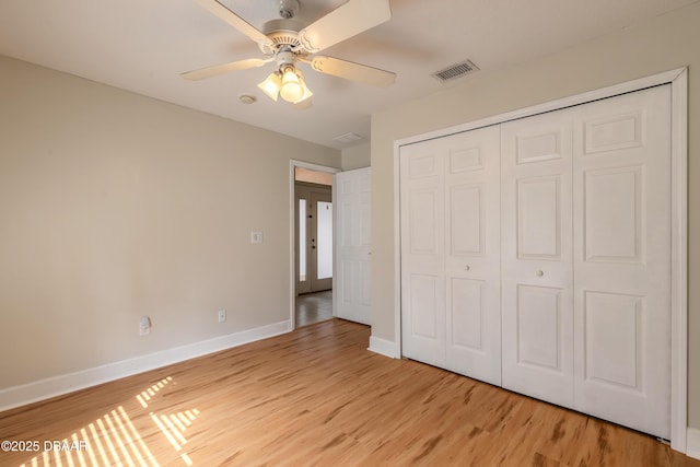 unfurnished bedroom with a closet, ceiling fan, and light wood-type flooring