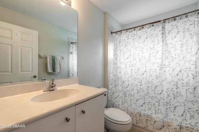 bathroom featuring vanity, curtained shower, and toilet