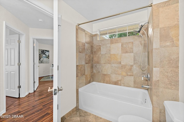 full bath with shower / washtub combination, wood finished floors, and toilet