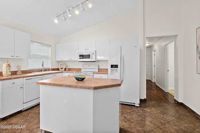 kitchen with white appliances, a sink, rail lighting, white cabinetry, and light countertops