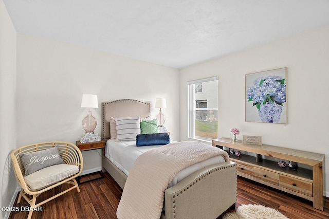bedroom with wood finished floors and baseboards