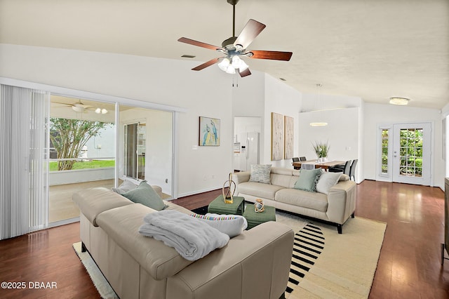 living room with lofted ceiling, healthy amount of natural light, wood finished floors, and a ceiling fan