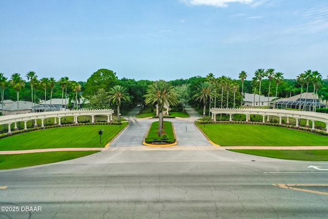 view of home's community with view of wooded area and a yard