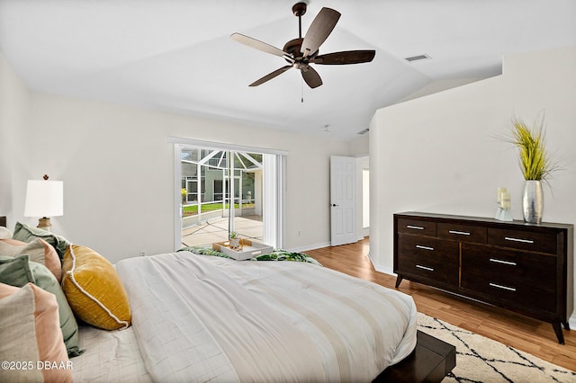 bedroom featuring access to outside, vaulted ceiling, light wood-type flooring, ceiling fan, and baseboards