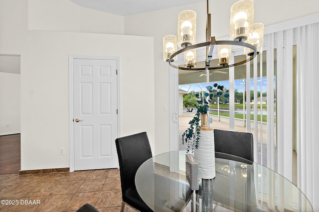 dining area with a chandelier and baseboards
