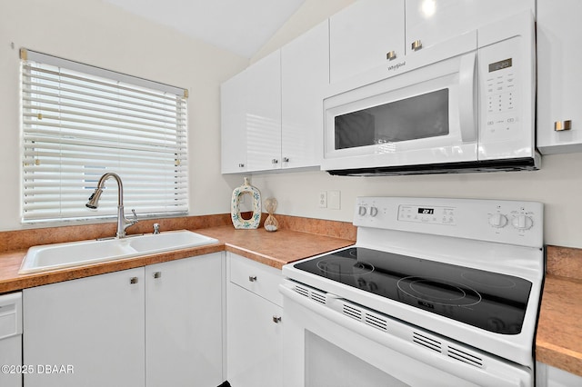 kitchen with white appliances, a sink, white cabinetry, light countertops, and vaulted ceiling