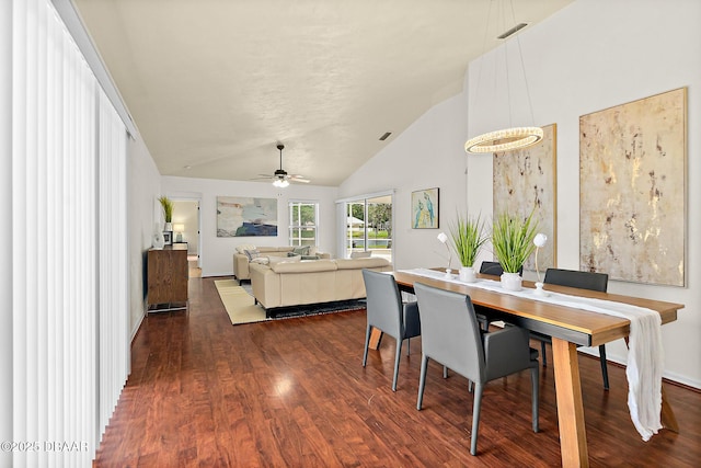 dining room featuring dark wood-type flooring, ceiling fan, high vaulted ceiling, and baseboards