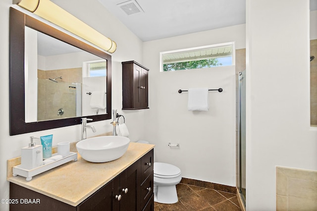 bathroom featuring a stall shower, toilet, tile patterned floors, and vanity