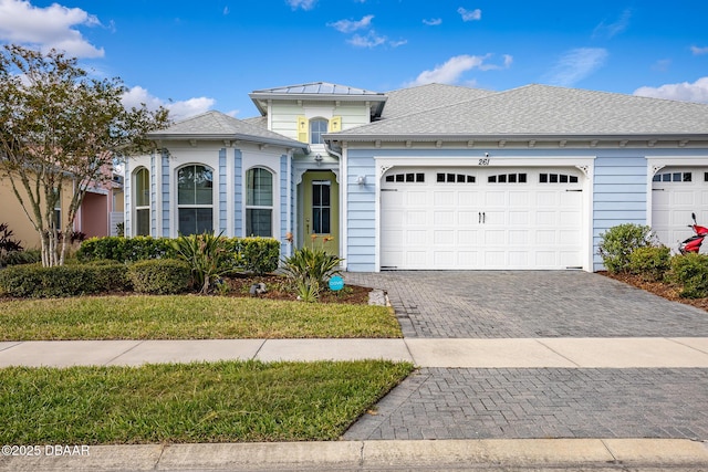 view of front facade with a front yard and a garage