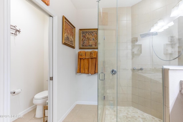 bathroom featuring tile patterned floors, toilet, and a shower with shower door