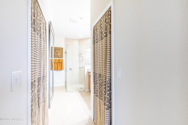 hall with light tile patterned floors