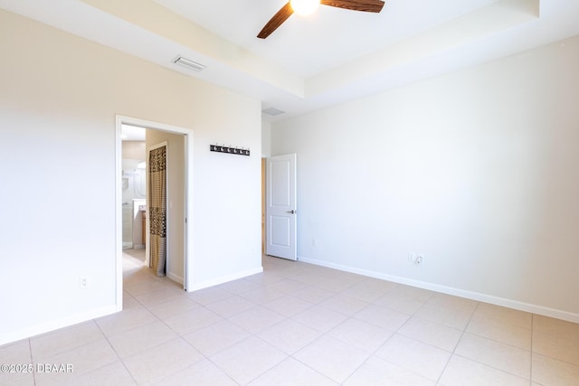 unfurnished bedroom featuring a raised ceiling and ceiling fan