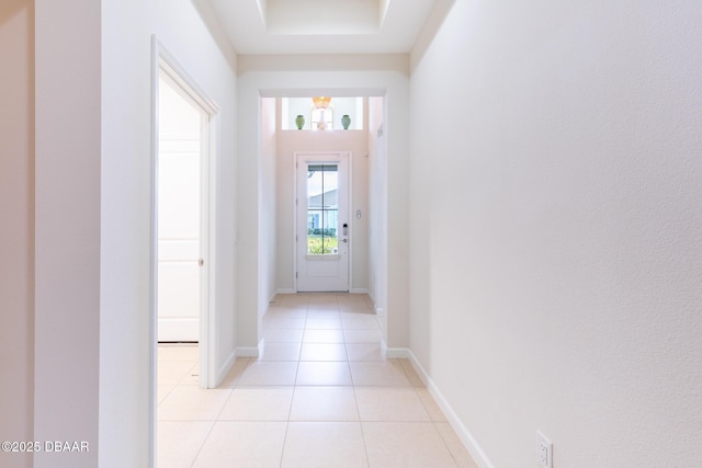 doorway to outside with light tile patterned floors