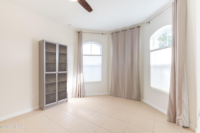 spare room featuring plenty of natural light and ceiling fan