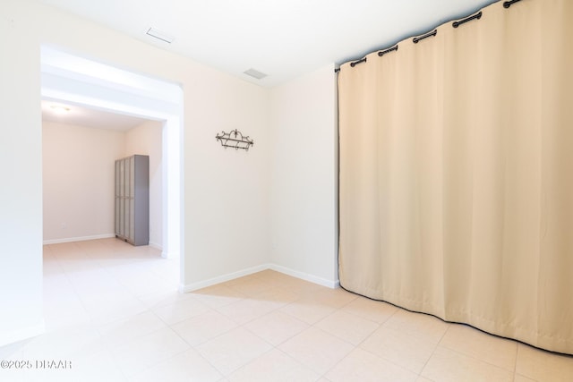 unfurnished room featuring light tile patterned floors