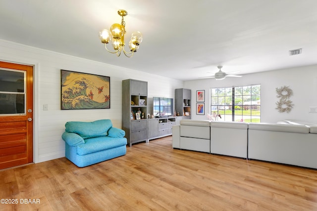 2530 Nordman Ave, New Smyrna Beach, FL 32168 - living area featuring a chandelier, light wood finished floors, and a ceiling fan