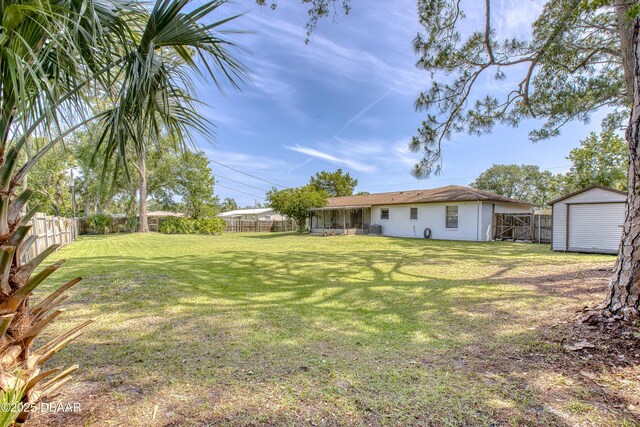 2530 Nordman Ave, New Smyrna Beach, FL 32168 - view of yard with a storage unit, an outdoor structure, a garage, and central air condition unit