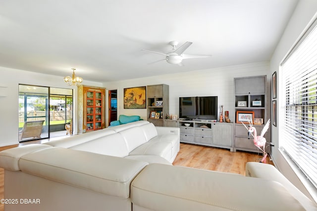 2530 Nordman Ave, New Smyrna Beach, FL 32168 - living room with light wood-style flooring, plenty of natural light, a chandelier, and ceiling fan