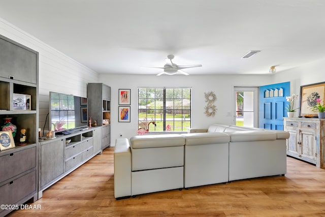 2530 Nordman Ave, New Smyrna Beach, FL 32168 - living area with ceiling fan, healthy amount of natural light, and light wood-style flooring