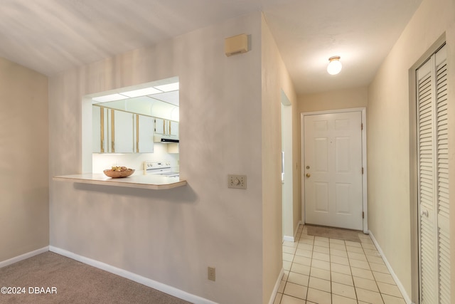 hall featuring light tile patterned flooring