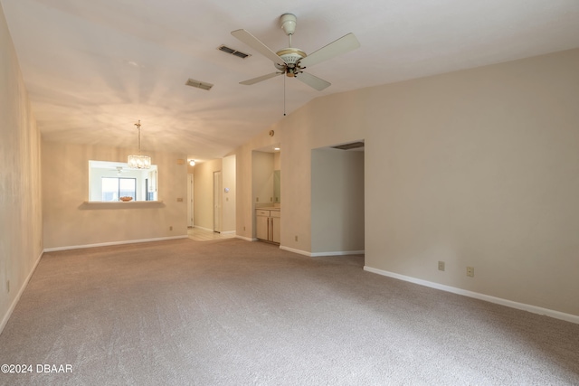 carpeted empty room featuring ceiling fan with notable chandelier