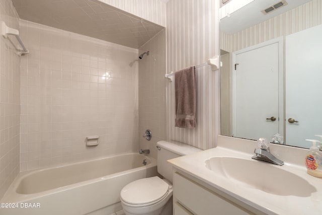 full bathroom with tiled shower / bath combo, toilet, and vanity