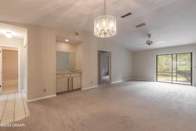 unfurnished living room featuring vaulted ceiling, sink, light colored carpet, and ceiling fan with notable chandelier