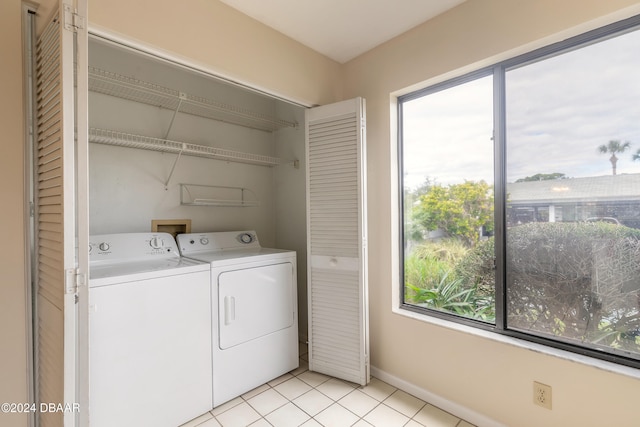 laundry area with separate washer and dryer, plenty of natural light, and light tile patterned flooring