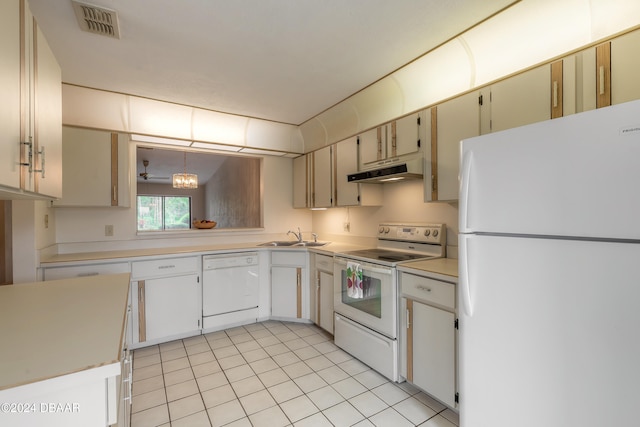 kitchen with white appliances, sink, a notable chandelier, hanging light fixtures, and light tile patterned flooring