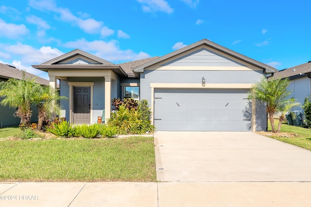 view of front of house with a garage and a front yard