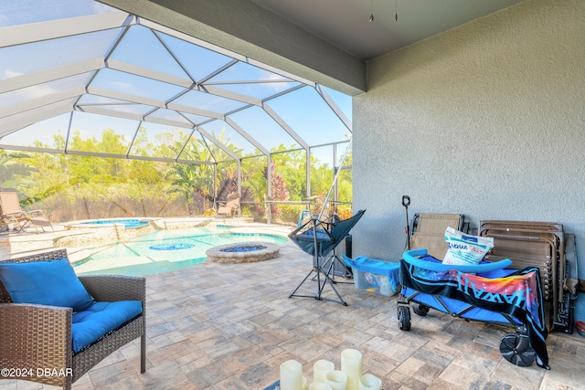 view of patio featuring a lanai and a swimming pool with hot tub