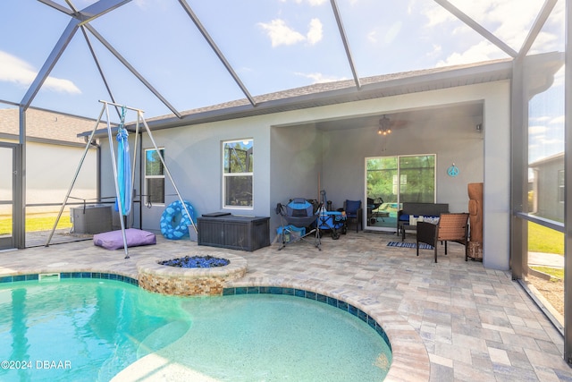 view of pool with a patio and glass enclosure