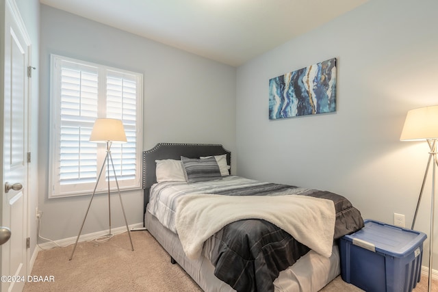 bedroom featuring light carpet and multiple windows