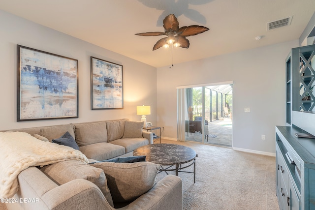 carpeted living room with ceiling fan