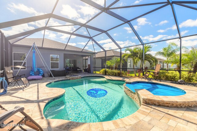 view of swimming pool with a patio, a lanai, and an in ground hot tub