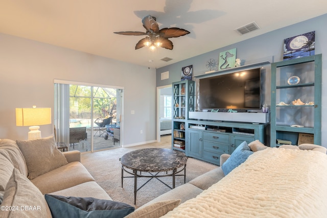 carpeted living room with ceiling fan