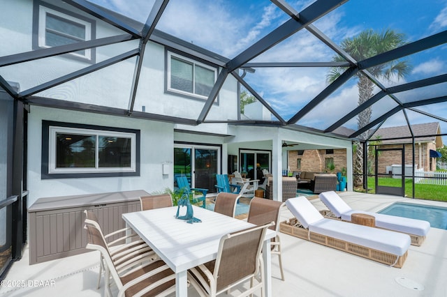 view of patio / terrace with ceiling fan, a lanai, a pool, and an outdoor living space