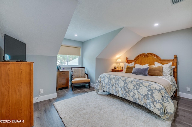 bedroom featuring vaulted ceiling and dark wood-type flooring