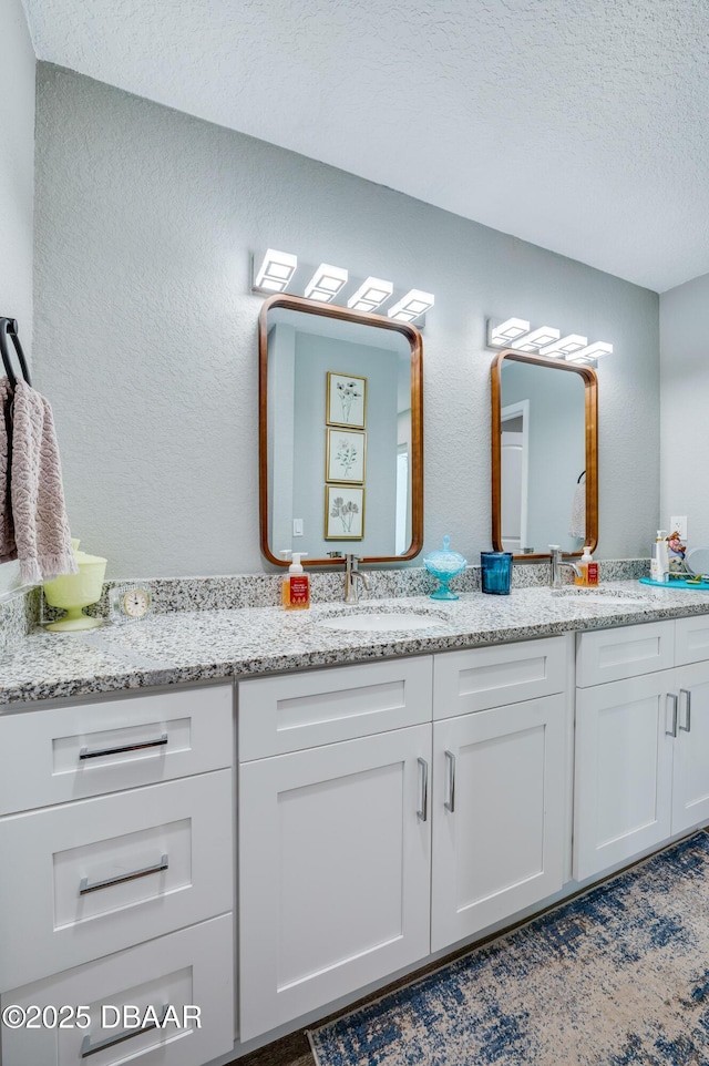 bathroom with vanity and a textured ceiling