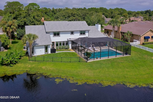 rear view of property with a lawn, a fenced in pool, a lanai, and a water view