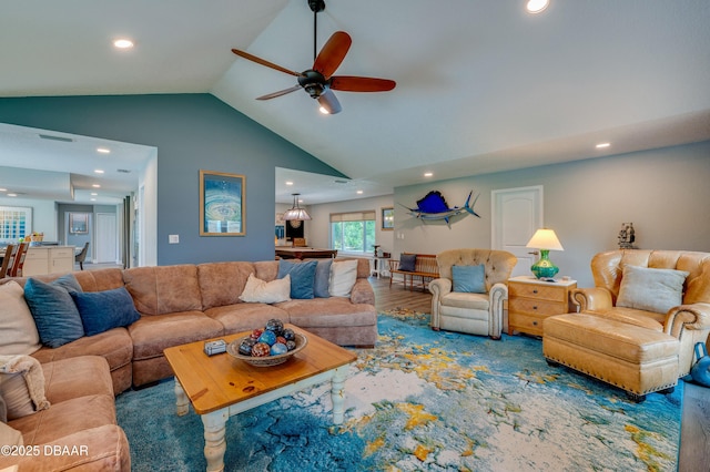 living room with hardwood / wood-style floors, high vaulted ceiling, and ceiling fan