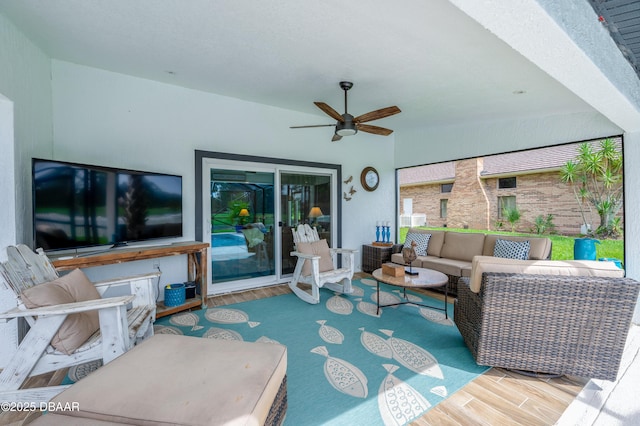 living room with hardwood / wood-style floors and ceiling fan