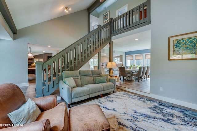 living room featuring high vaulted ceiling