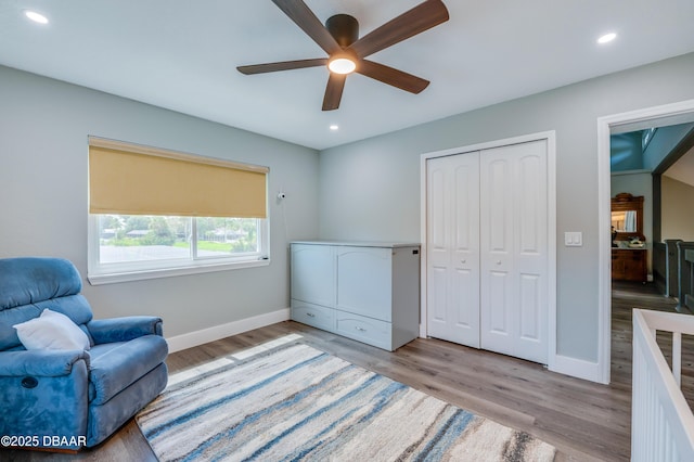 sitting room featuring light hardwood / wood-style flooring and ceiling fan