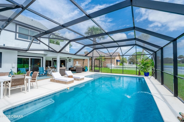 view of pool with an outdoor living space, a patio, and glass enclosure