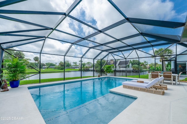 view of swimming pool with glass enclosure, a patio area, and a water view